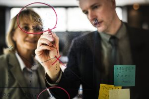 Businesspeople planning on a glass wall